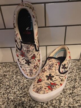 Vans Stranger Things Cream Slip-On Sneakers with Black Trim and Red Tattoo Print
